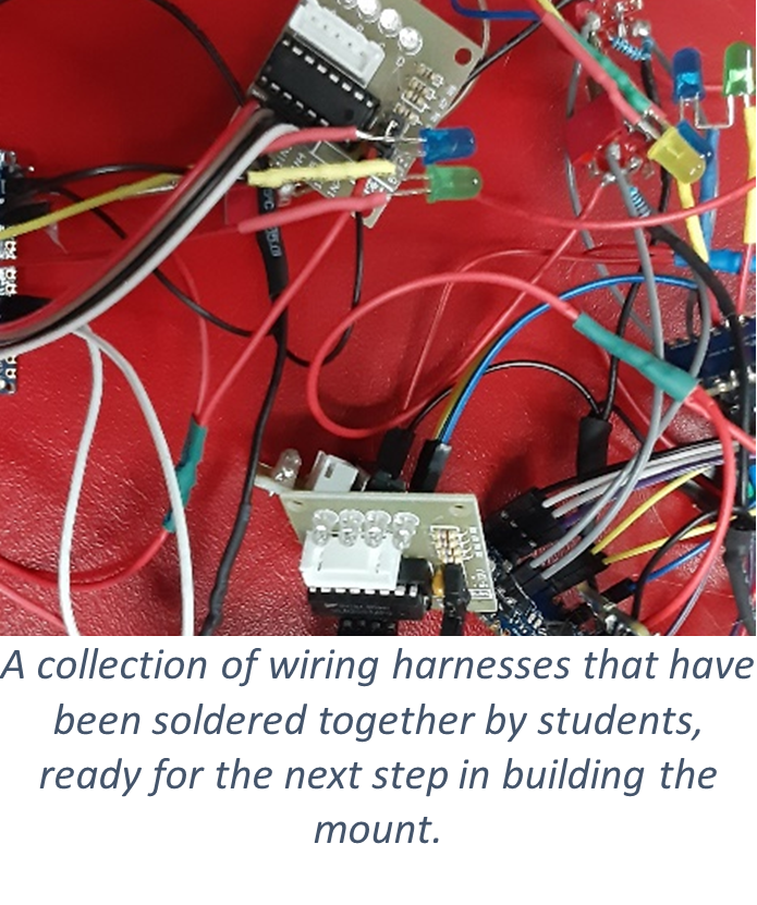 2-3 small circuit boards with wires and electrical parts attached